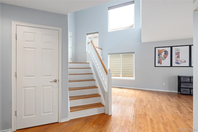 stairs with hardwood / wood-style flooring and baseboards