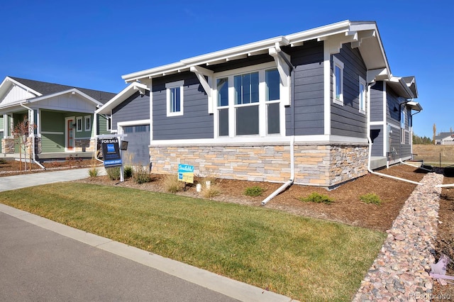 view of side of home with a lawn and a garage