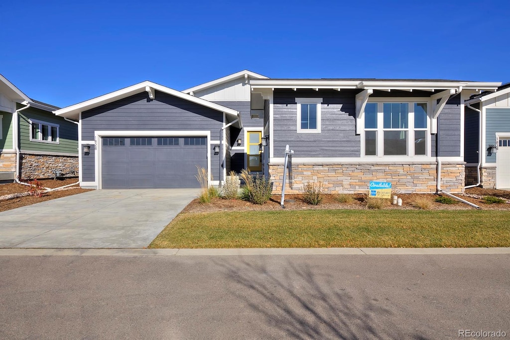 view of front of house featuring a garage and a front lawn