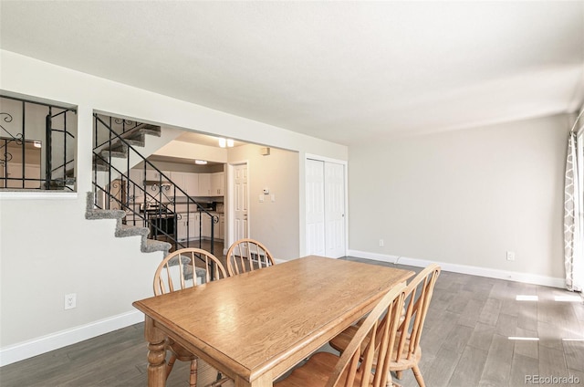 12020 E Canal Dr, Aurora, CO 80011 - dining space featuring wood finished floors, baseboards, and stairs