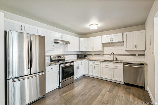 12020 E Canal Dr, Aurora, CO 80011 - kitchen featuring appliances with stainless steel finishes, a sink, white cabinetry, and decorative backsplash