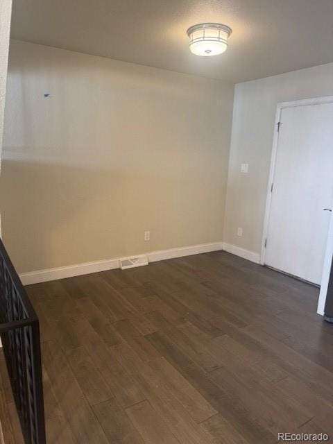12020 E Canal Dr, Aurora, CO 80011 - unfurnished room with dark wood-style floors and baseboards