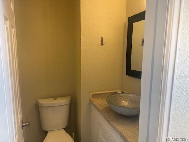 12020 E Canal Dr, Aurora, CO 80011 - half bathroom featuring vanity and toilet