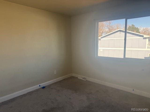 12020 E Canal Dr, Aurora, CO 80011 - spare room featuring baseboards and carpet