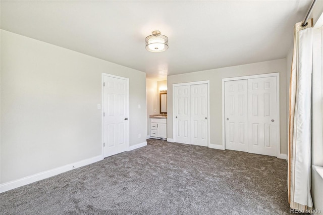 12020 E Canal Dr, Aurora, CO 80011 - unfurnished bedroom with multiple closets, carpet flooring, and baseboards