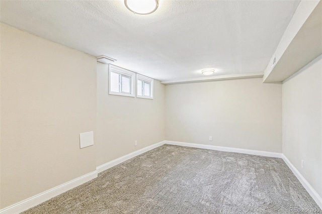 12020 E Canal Dr, Aurora, CO 80011 - below grade area featuring carpet flooring, baseboards, and a textured ceiling