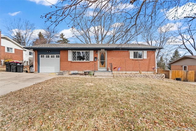 ranch-style home with concrete driveway, brick siding, an attached garage, and a front yard