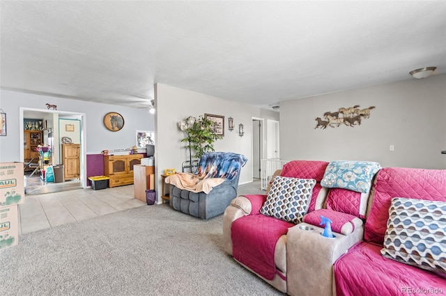 living room featuring light tile patterned floors, ceiling fan, and light colored carpet