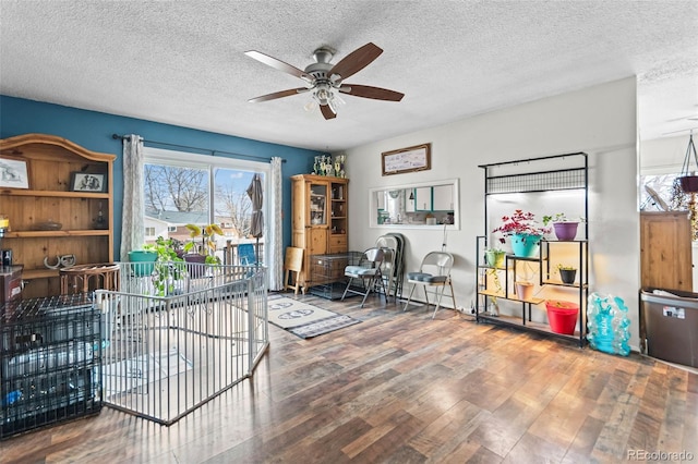 office space with ceiling fan, a textured ceiling, and wood finished floors