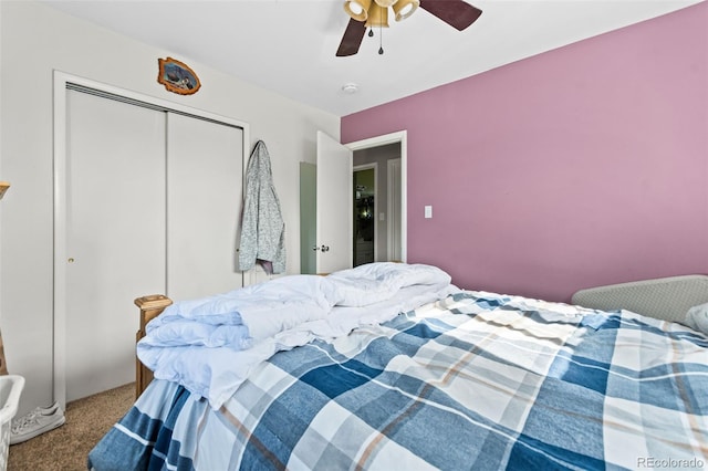 carpeted bedroom featuring a ceiling fan and a closet