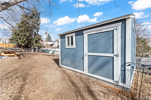 view of shed featuring fence