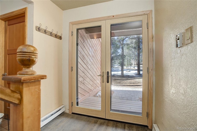 entryway featuring wood-type flooring, french doors, and baseboard heating