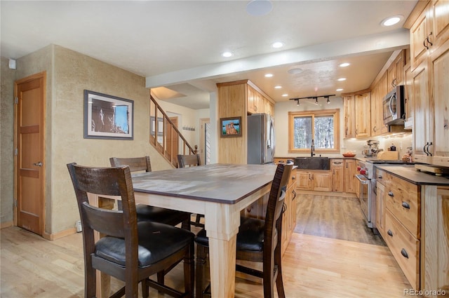 dining area featuring light hardwood / wood-style floors and sink