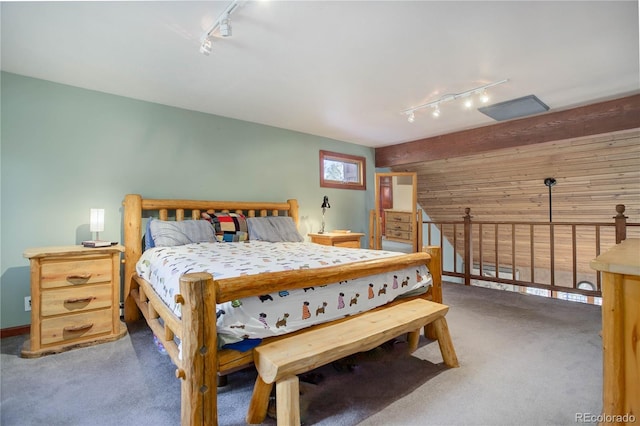 bedroom featuring dark colored carpet and rail lighting