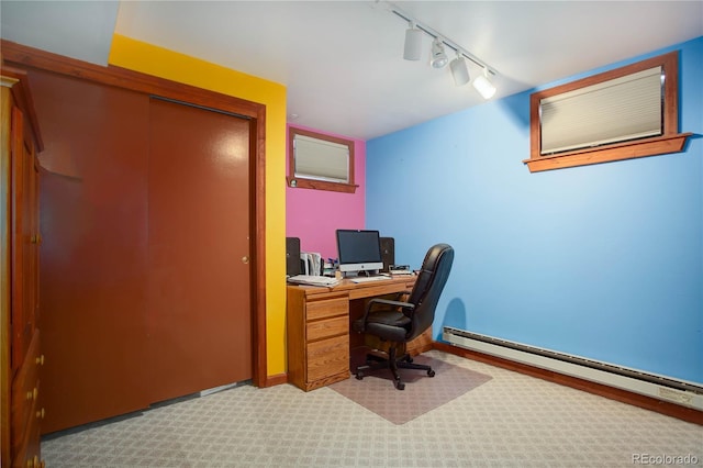 carpeted home office featuring a baseboard radiator and track lighting