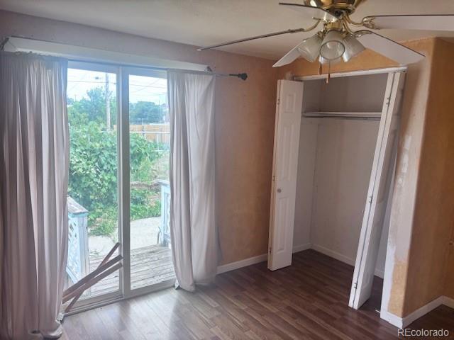 310 E Strong Ave, Trinidad, CO 81082 - unfurnished bedroom featuring access to outside, wood finished floors, a closet, and a ceiling fan