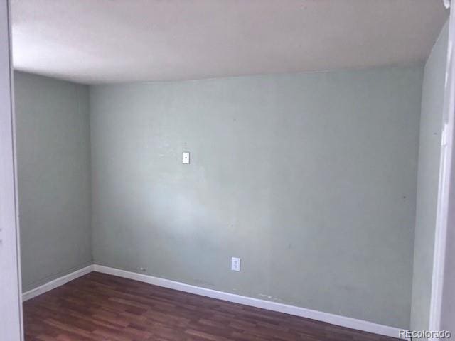 310 E Strong Ave, Trinidad, CO 81082 - unfurnished room with dark wood-style floors and baseboards