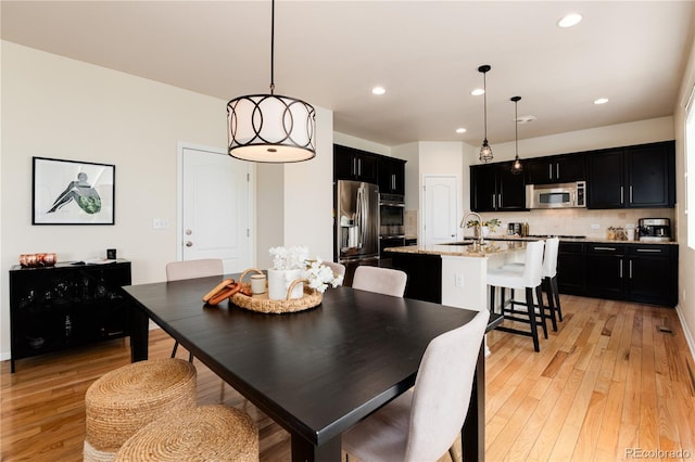 3027 Walnut Grove St, Erie, CO 80516 - dining room with light wood finished floors and recessed lighting