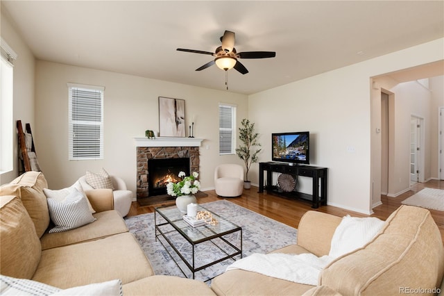 3027 Walnut Grove St, Erie, CO 80516 - living room featuring ceiling fan, wood finished floors, and a stone fireplace