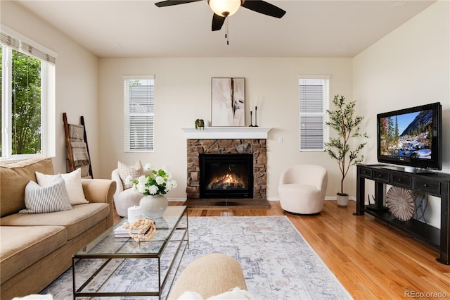 3027 Walnut Grove St, Erie, CO 80516 - living room featuring light wood-style floors, a ceiling fan, and a fireplace