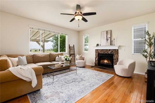 3027 Walnut Grove St, Erie, CO 80516 - living area with hardwood / wood-style floors, ceiling fan, and a fireplace