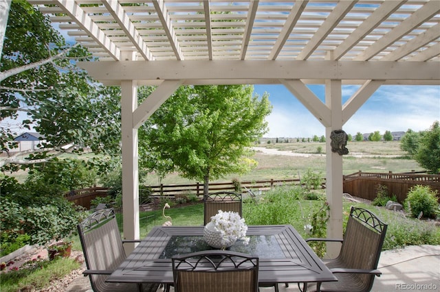 3027 Walnut Grove St, Erie, CO 80516 - fenced backyard with outdoor dining space, a pergola, and a view of countryside