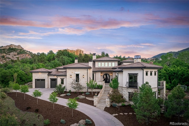 view of front of home with a mountain view and a garage