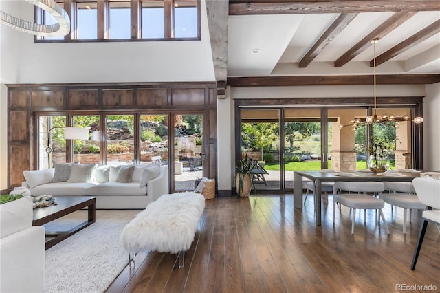 living room featuring beamed ceiling and dark hardwood / wood-style floors