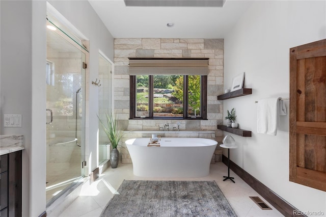 bathroom featuring shower with separate bathtub, tile patterned flooring, and vanity