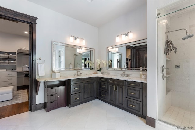 bathroom featuring vanity, hardwood / wood-style floors, and tiled shower