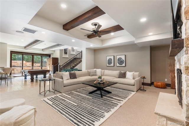 carpeted living room featuring pool table, beamed ceiling, and a stone fireplace