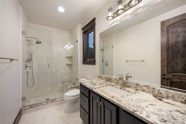 bathroom with tile patterned floors, walk in shower, vanity, and toilet