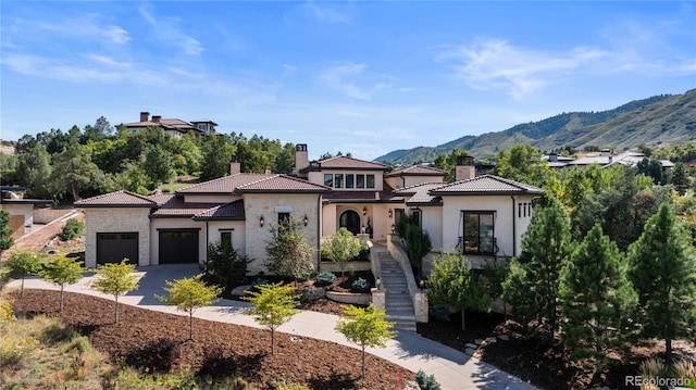 mediterranean / spanish home with a mountain view and a garage