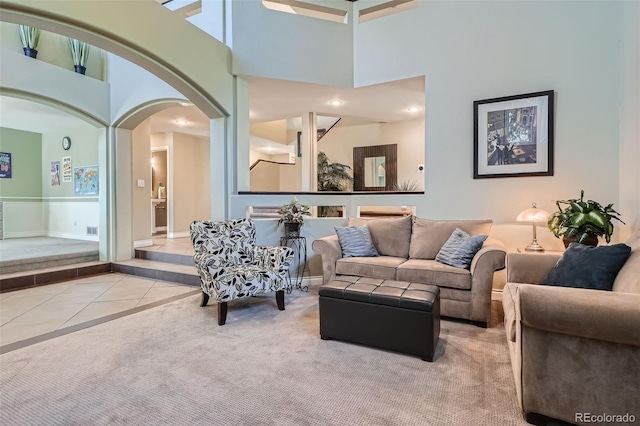 tiled living room with a high ceiling