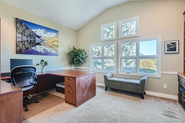 office space featuring light carpet and vaulted ceiling