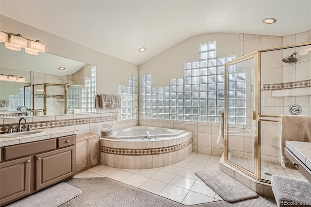 bathroom with vaulted ceiling, tile patterned flooring, vanity, and plus walk in shower