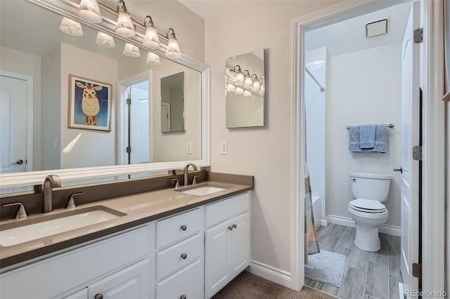 full bathroom with shower / bath combo, vanity, and toilet