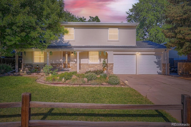 2514 S Elkhart St, Aurora, CO 80014 - traditional home with driveway, covered porch, stucco siding, and stone siding