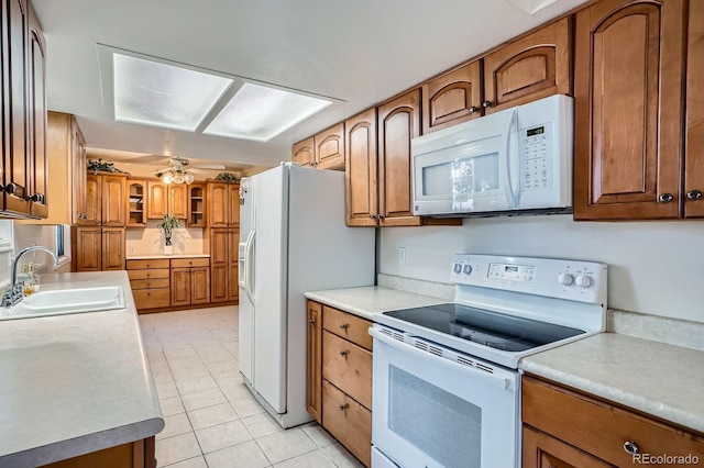 2514 S Elkhart St, Aurora, CO 80014 - kitchen featuring white appliances, brown cabinets, light tile patterned floors, ceiling fan, and light countertops