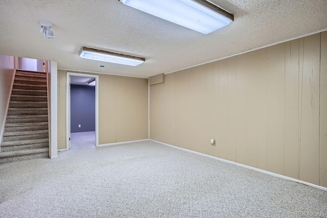 2514 S Elkhart St, Aurora, CO 80014 - finished basement with a textured ceiling, stairs, and carpet floors