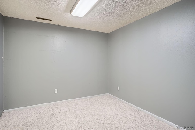 2514 S Elkhart St, Aurora, CO 80014 - empty room featuring a textured ceiling and carpet floors