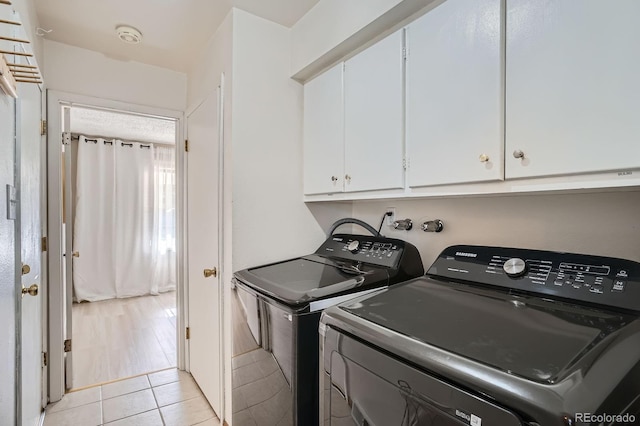 2514 S Elkhart St, Aurora, CO 80014 - laundry room featuring cabinet space, separate washer and dryer, and light tile patterned flooring