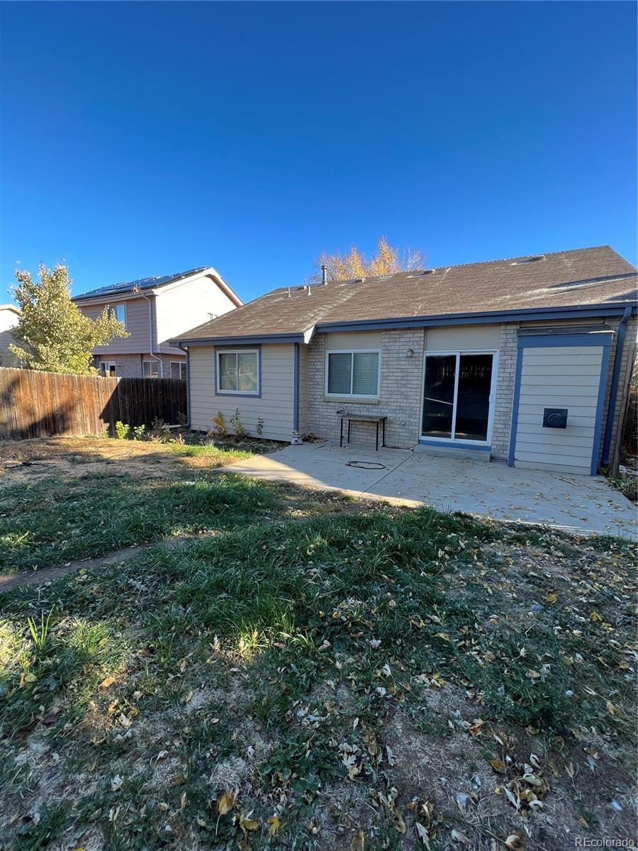 back of house featuring a yard and a patio