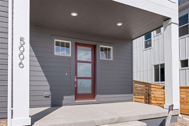 view of exterior entry with board and batten siding