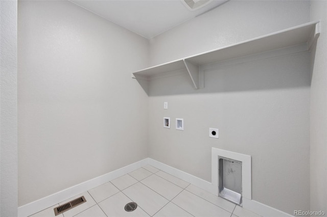 laundry area with hookup for a washing machine, hookup for an electric dryer, light tile patterned floors, and baseboards