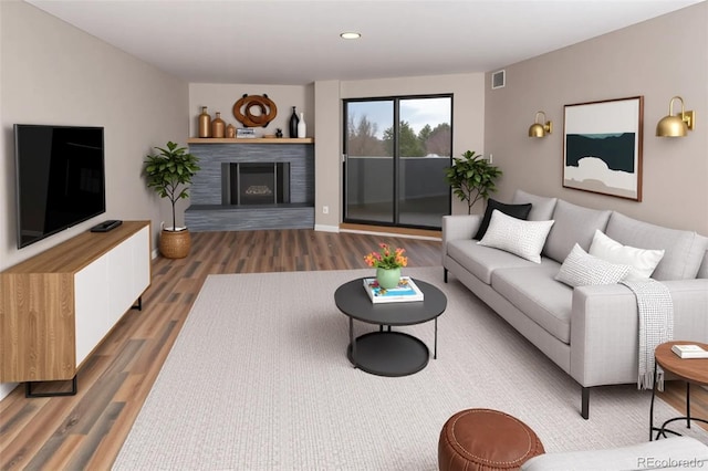 7255 E Quincy Ave Unit 205, Denver, CO 80237 - living area featuring wood finished floors, a fireplace with raised hearth, and recessed lighting