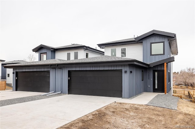 view of front of house featuring board and batten siding, roof with shingles, driveway, and an attached garage