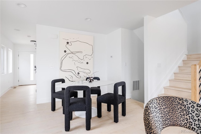 dining area with light wood-type flooring, visible vents, recessed lighting, and stairs