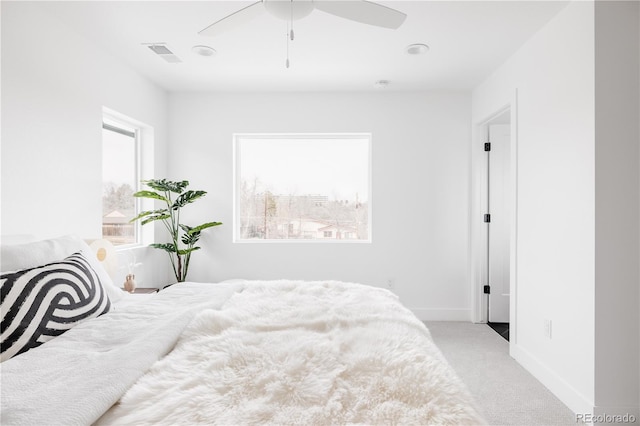 bedroom featuring visible vents, ceiling fan, light carpet, and baseboards