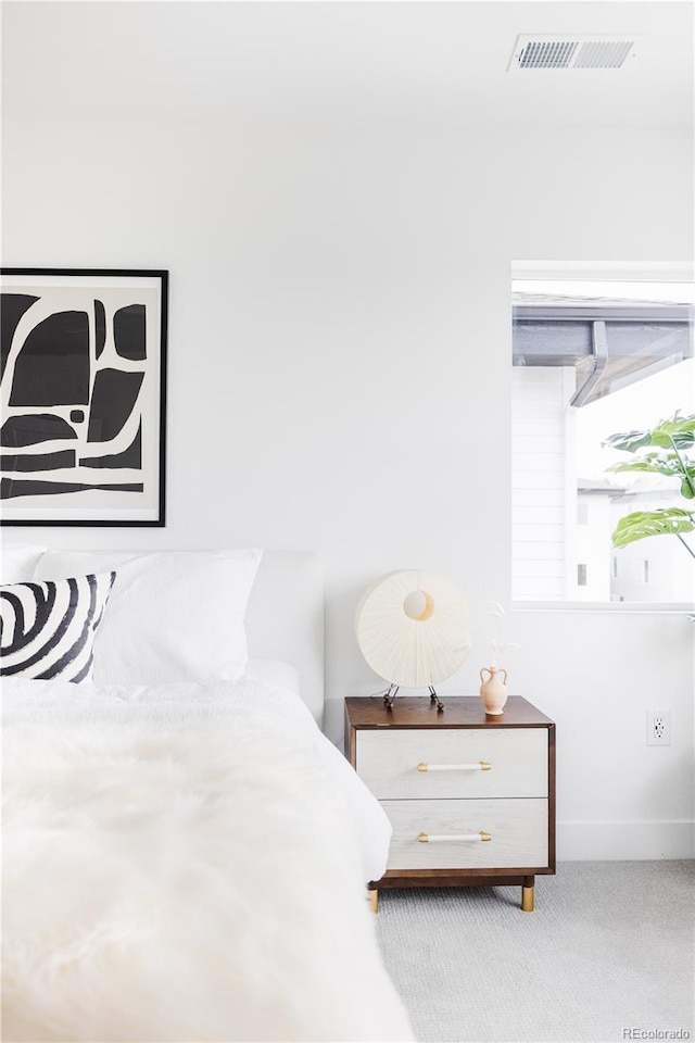 bedroom featuring carpet, visible vents, and baseboards